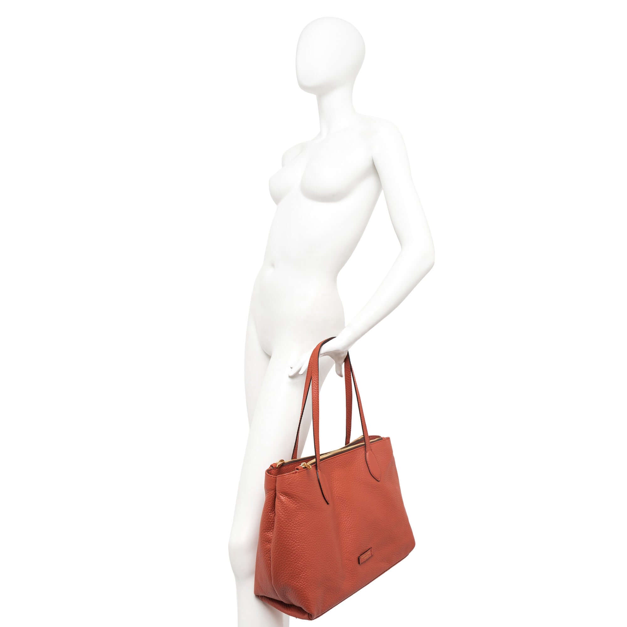 Elegant maxi grain leather shopping bag in rust color, featuring double zip closure and three inner compartments.