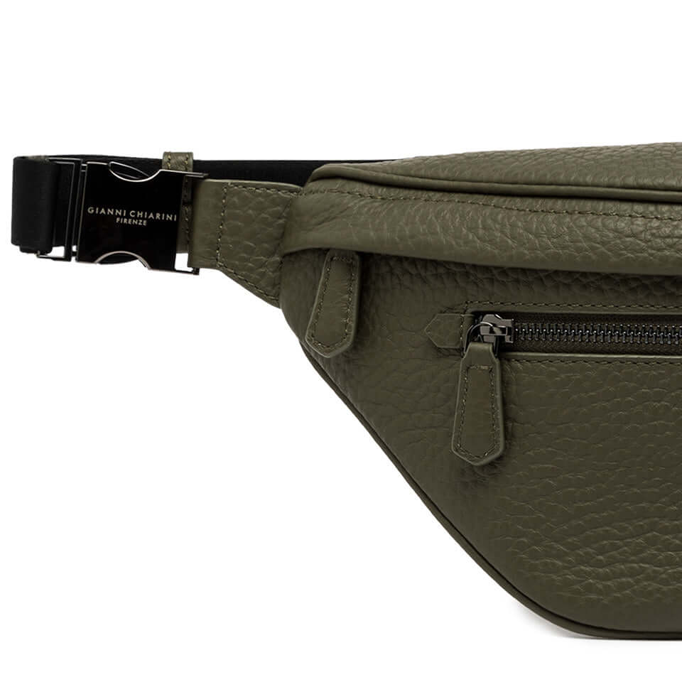 FLORENCE green leather fanny pack with zip pocket, minimal design and adjustable buckle closure for daily use.