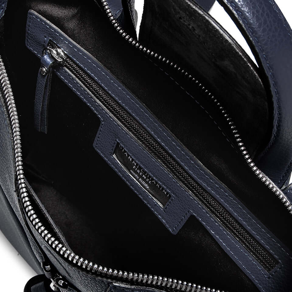 Inside view of the GIADA handbag showing zip pocket and multi-use compartments, crafted from pebbled leather.
