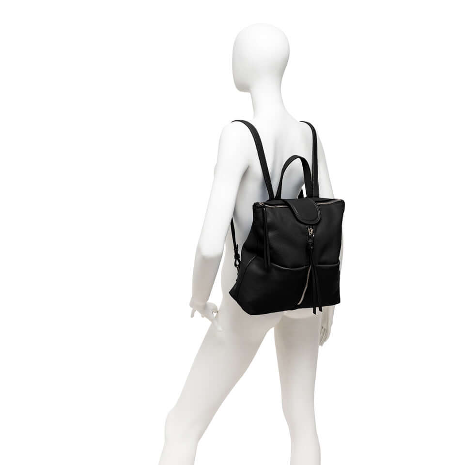 Black leather backpack with adjustable straps, featuring flat front pockets and dual zippers, perfect accessory for any outfit.