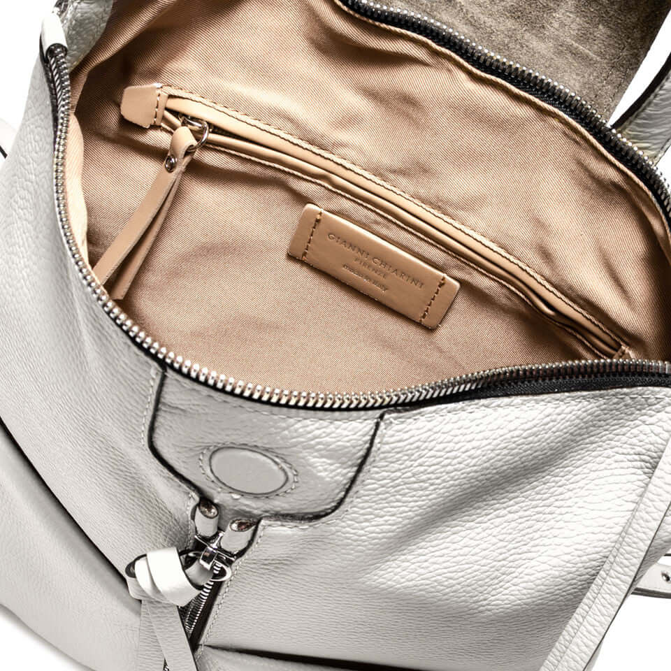 Interior view of the GIADA handbag, featuring a zip pocket and beige lining, showcasing pockets and a stylish design.
