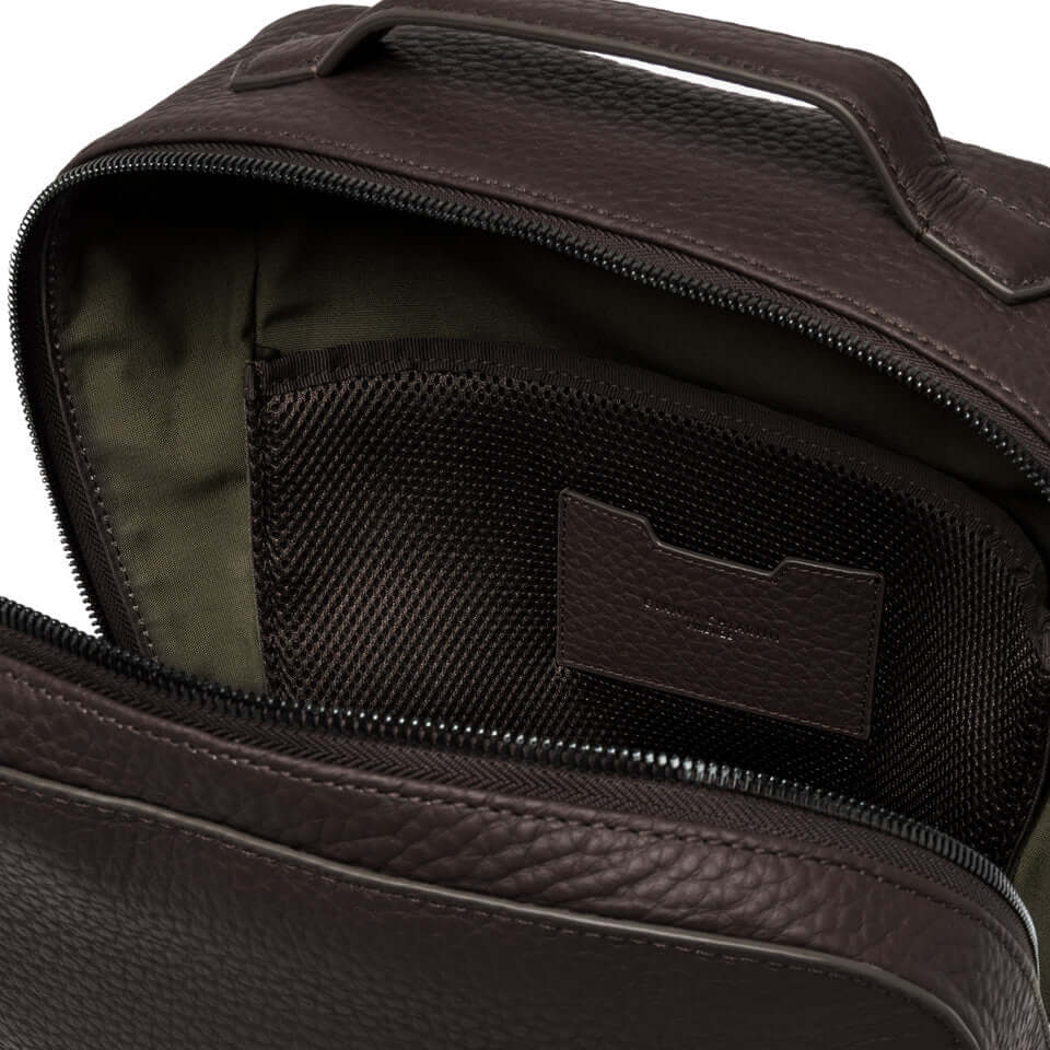Interior view of the FLORENCE leather backpack by Gianni Chiarini, featuring a zippered compartment and organizational pocket.