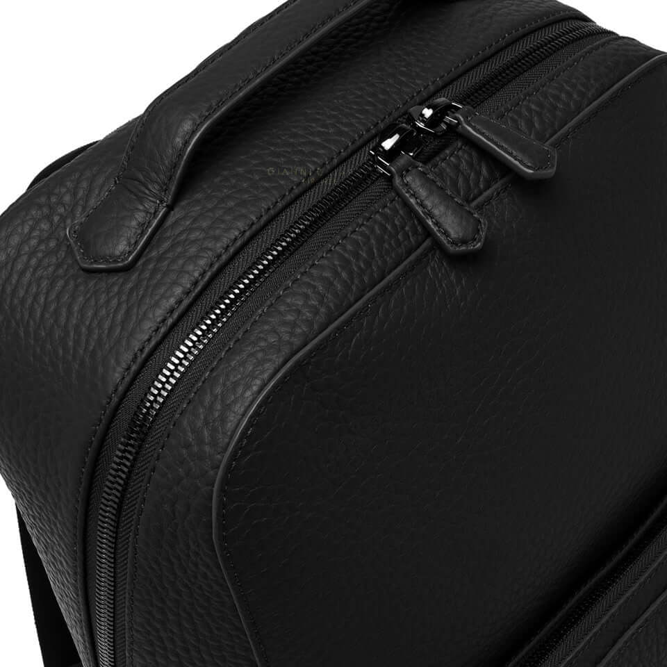 Close-up of the black leather FLORENCE backpack by Gianni Chiarini, showcasing its zippers and textured finish.