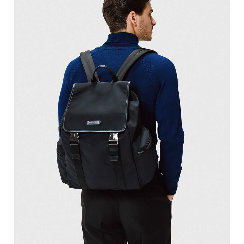 Man wearing the Oslo backpack by Gianni Chiarini Firenze, featuring a minimalist design and nylon material.