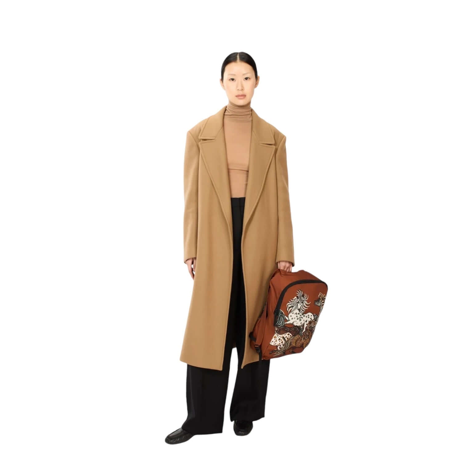 Model wearing a tan overcoat and holding a brown Zaino Western Marrone bag with a stylish design.