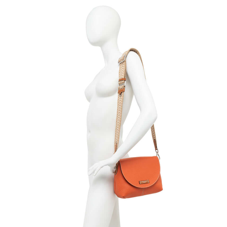 Orange Alessandra bag by Gianni Chiarini Firenze showcased on a mannequin, featuring a braided strap.