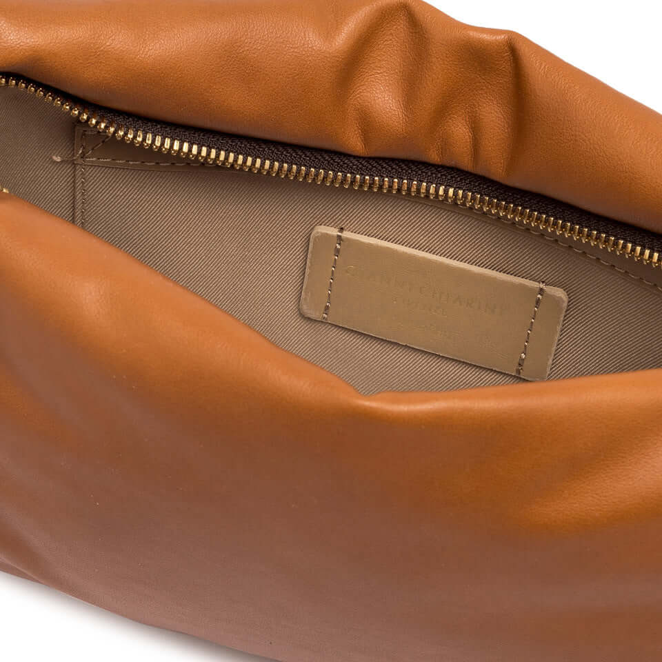 Inside view of Allegra clutch by Gianni Chiarini Firenze, showcasing soft leather, zip closure, and cream lining.