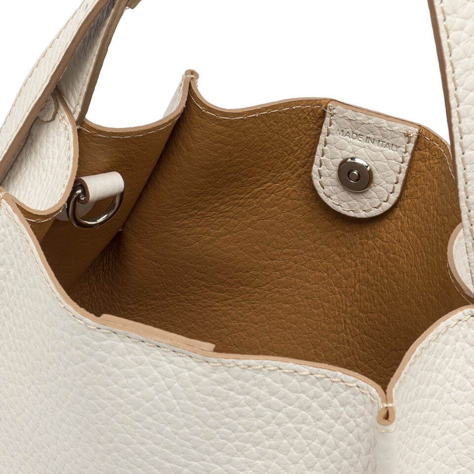 Interior view of a Dory handbag, featuring minimalistic design and a magnetic button closure.