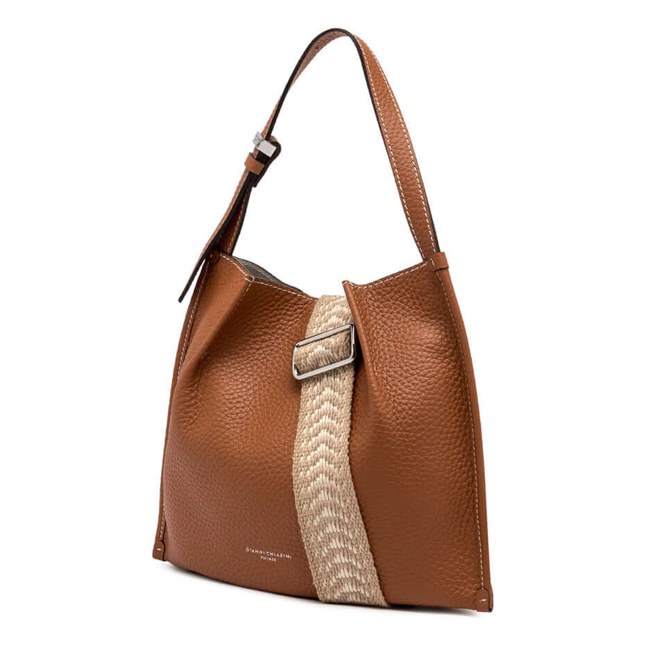 Dory handbag featuring a stylish brown leather and woven strap design, perfect for casual looks.