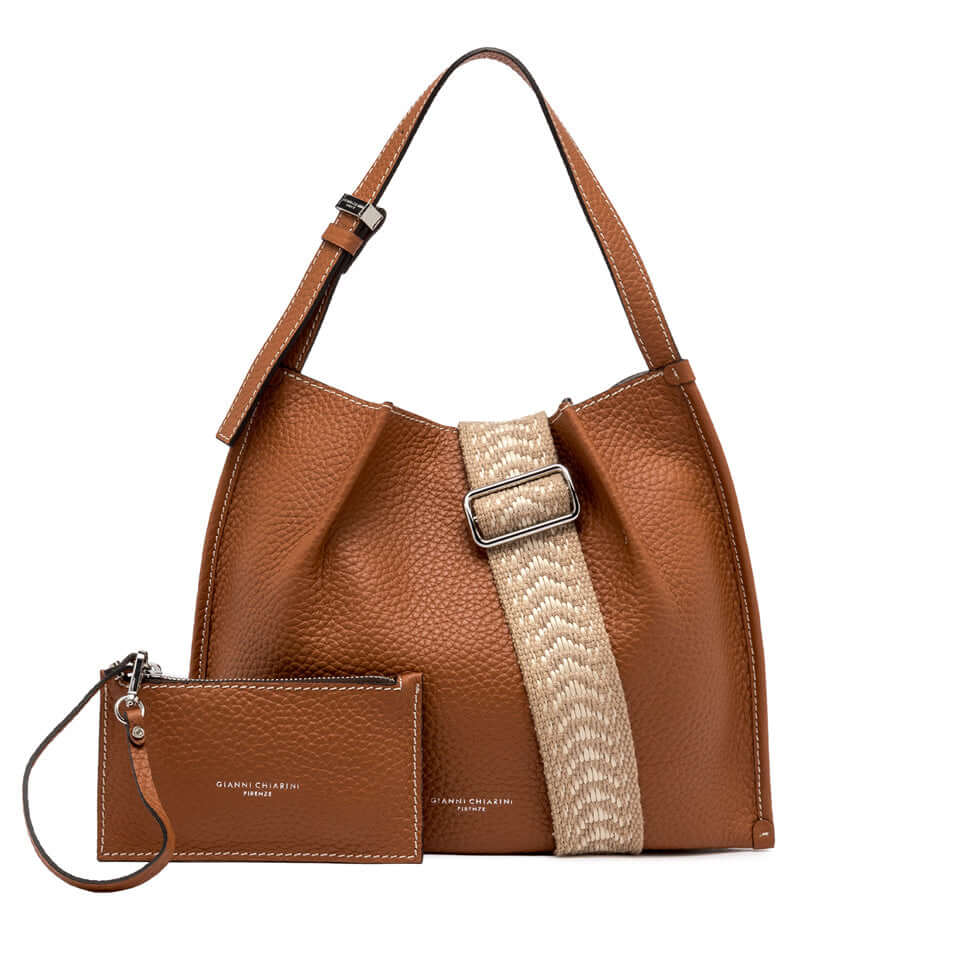 Dory brown leather handbag with woven strap and matching pouch, perfect for casual chic styles.