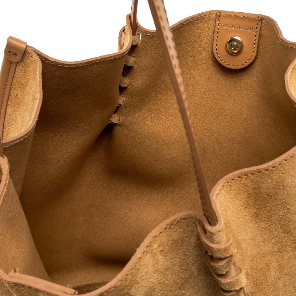 Interior view of Dory suede bag showcasing its simple design and adjustable twin logo passes.