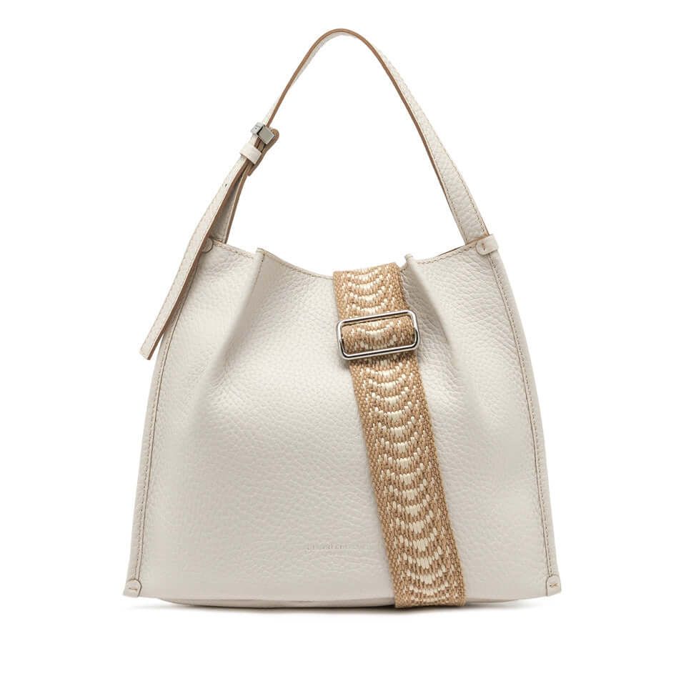 Dory handbag in cream leather with a woven strap and silver buckle, perfect for casual styling.