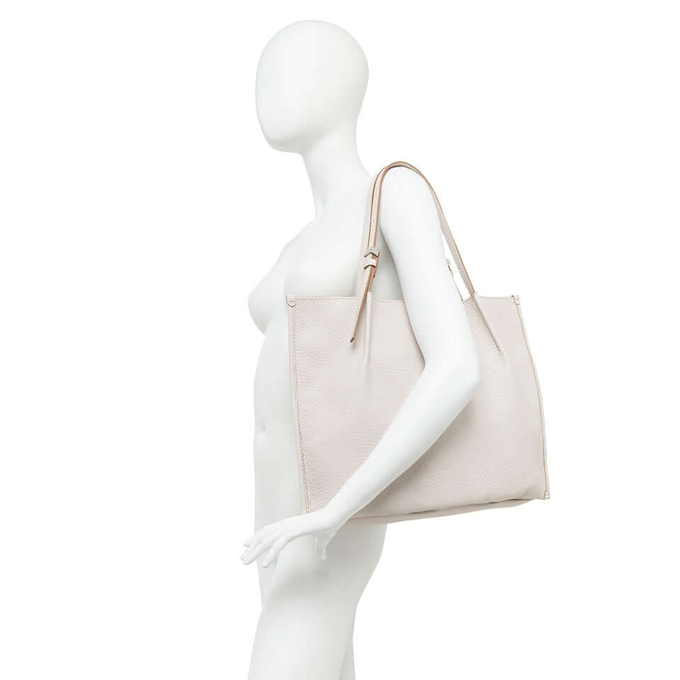 Dory lightweight leather bag in soft beige, perfect for casual styles and featuring adjustable handles.