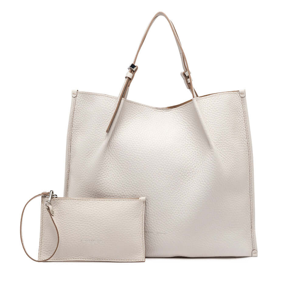 Dory leather tote bag in cream with detachable pouch, featuring simple design and adjustable straps.