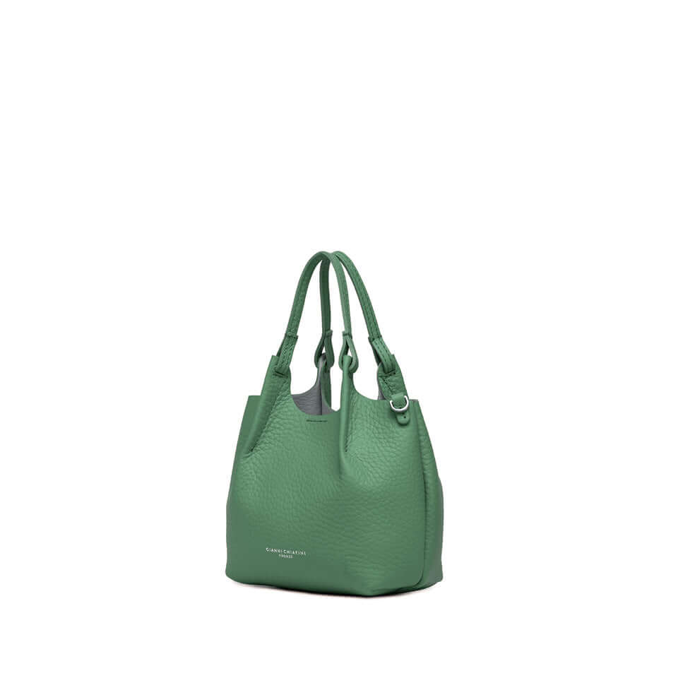 Stylish DUA green leather handbag featuring dual handles and a magnetic closure.