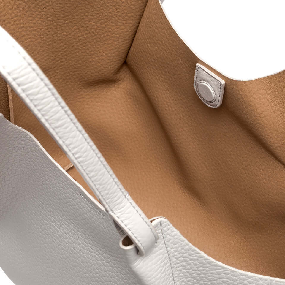 Interior view of DUA bag showcasing soft leather and magnetic closure, perfect for enhancing any outfit.