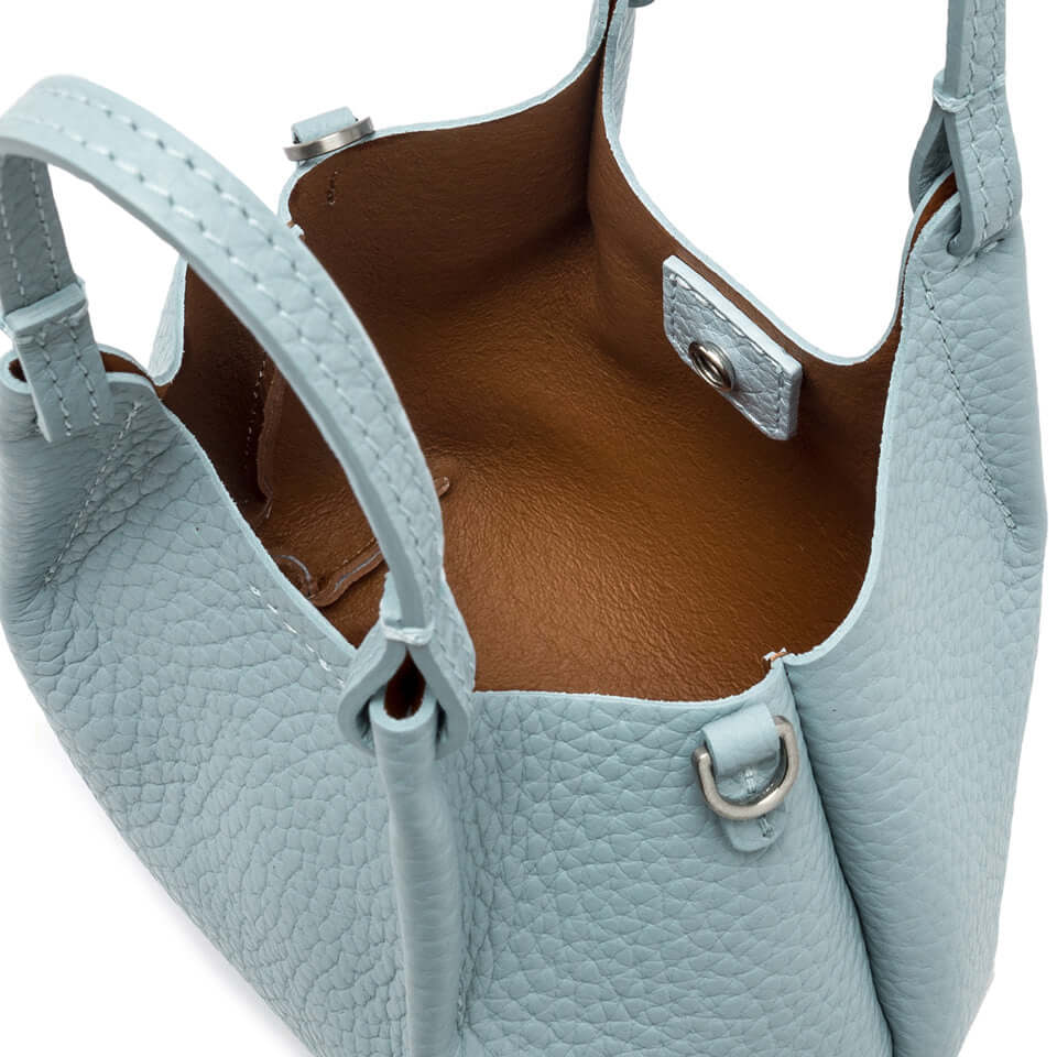 Interior view of DUA bag in light blue leather, showcasing the spacious and stylish design with magnetic closure.