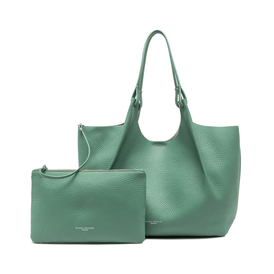 Green leather tote bag with matching pouch, showcasing contemporary design and versatile style.