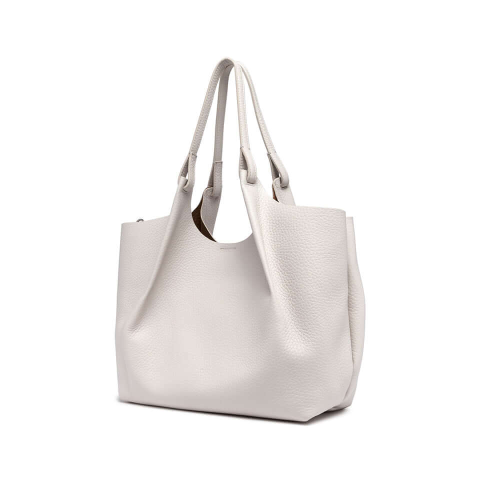 DUA simple contemporary leather tote bag with dual handles, measuring 34x38x16 cm, showcasing a stylish design.
