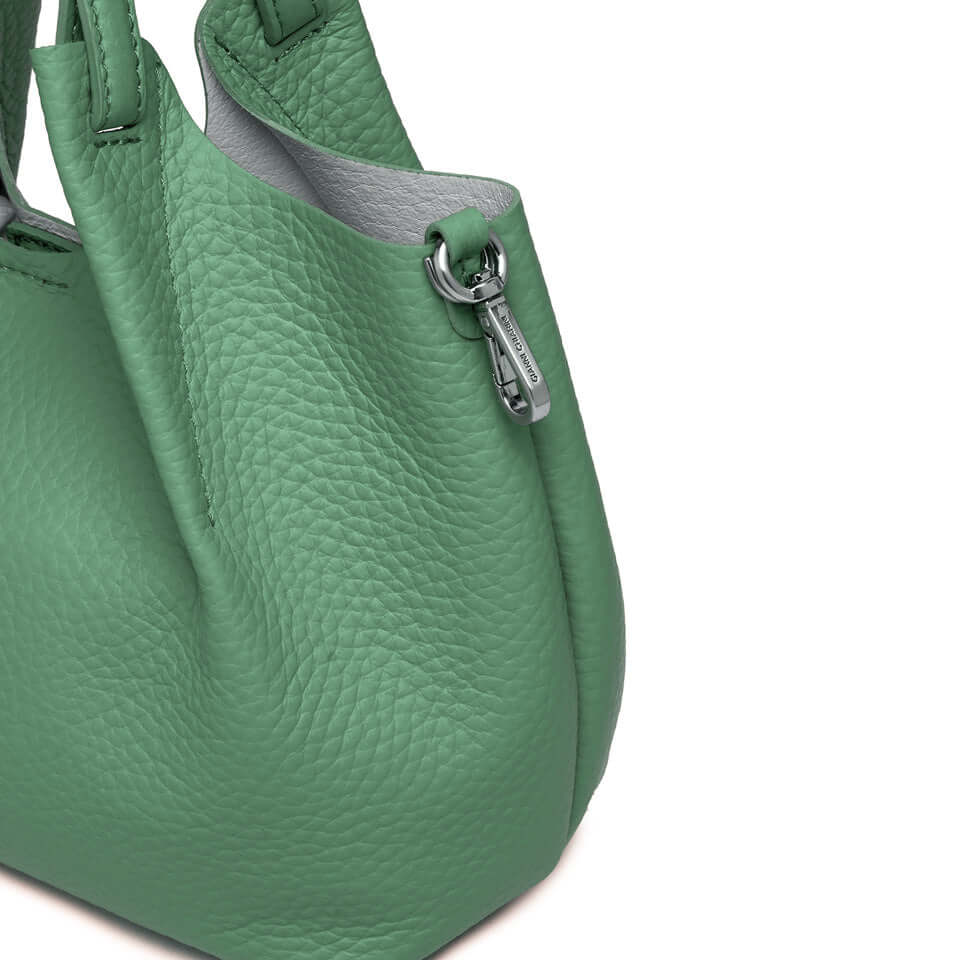 Contemporary green handbag from DUA, featuring textured leather and elegant design with silver accents.