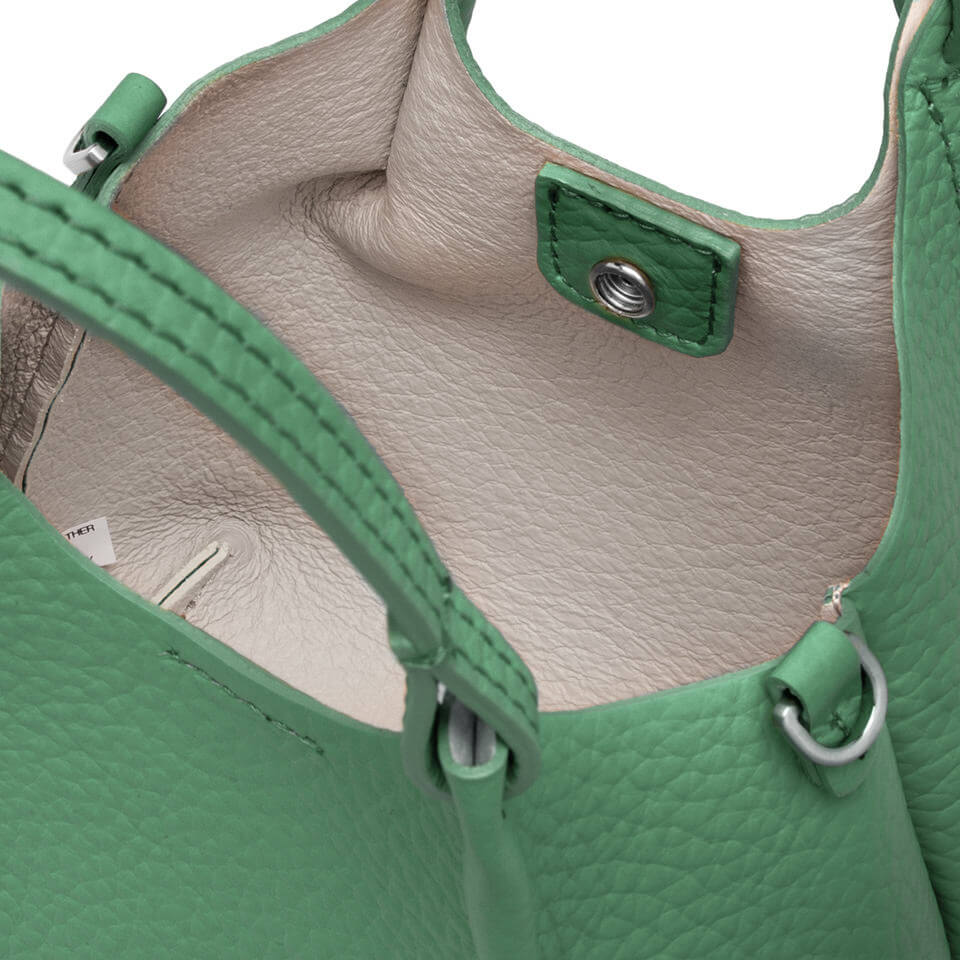 Interior view of the DUA green leather bag featuring a simple yet contemporary design.
