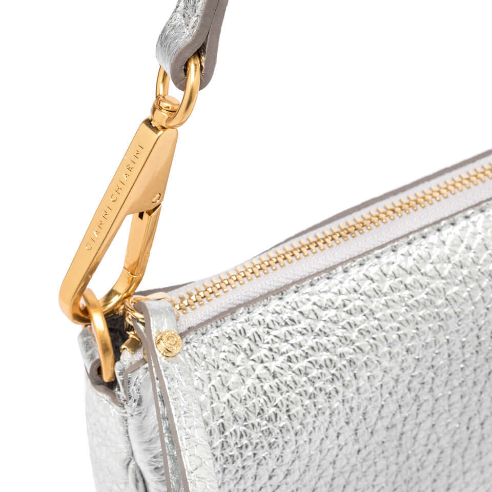 Close-up detail of the silver Brooke handbag by Gianni Chiarini, featuring a gold clasp and zip closure.