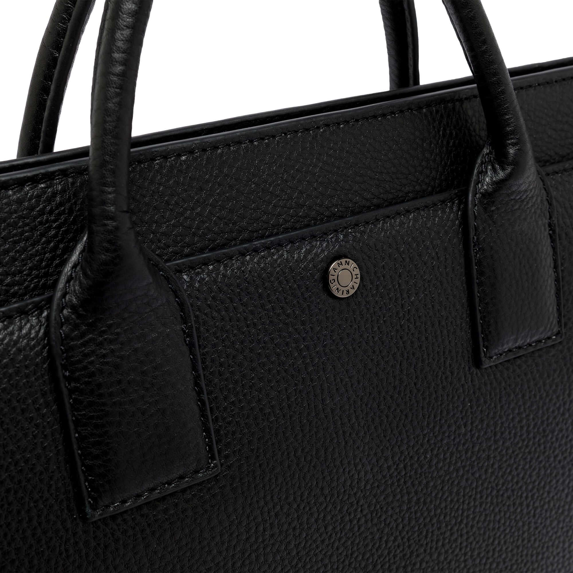 Close-up of the Florence leather bag, showcasing the textured black exterior and logo button detail.