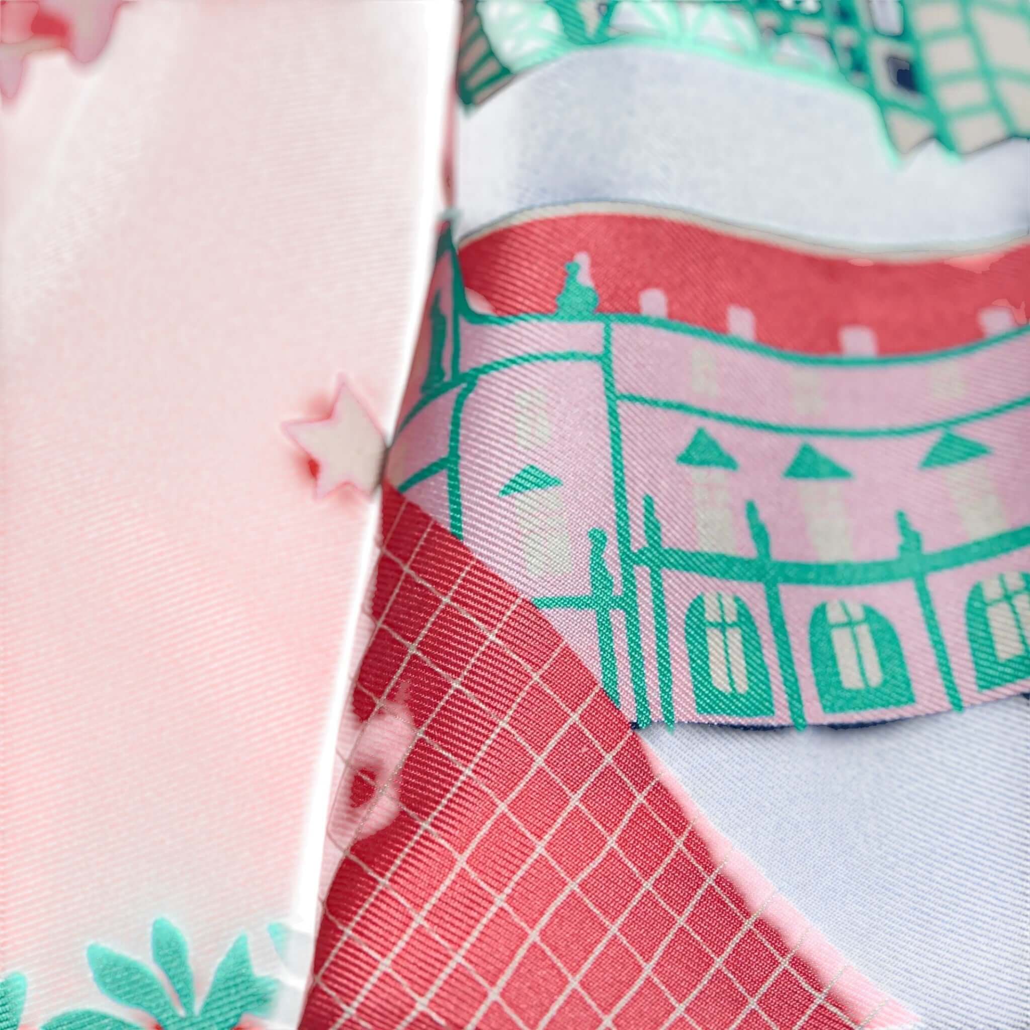 Close-up of the J'aime Paris silk scarf showcasing colorful, intricate designs and patterns.