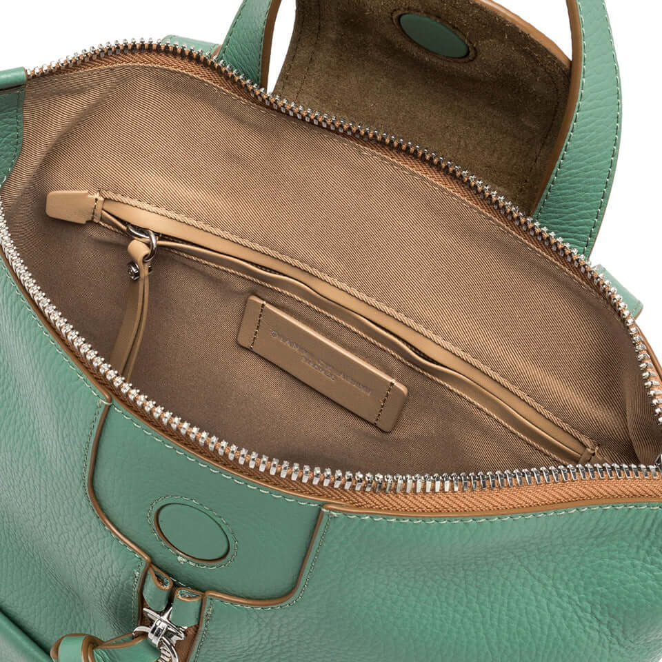 Interior view of Giada backpack by Gianni Chiarini Firenze, featuring zip pocket and multi-use compartments in light brown fabric.