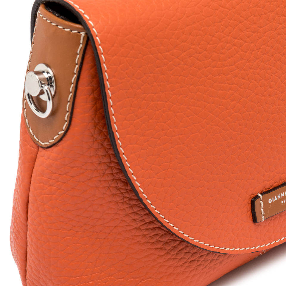 Detail of the Alessandra bag by Gianni Chiarini Firenze in textured orange leather with a flap and snap button closure.