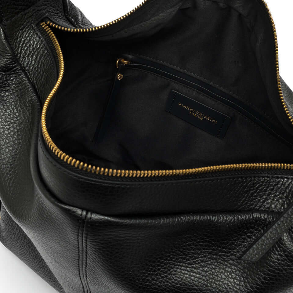 Interior of Guia bag by Gianni Chiarini Firenze featuring a spacious compartment and pocket.