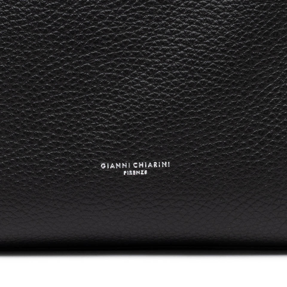 Logo of Gianni Chiarini Firenze embossed on a black leather surface, showcasing luxury craftsmanship.