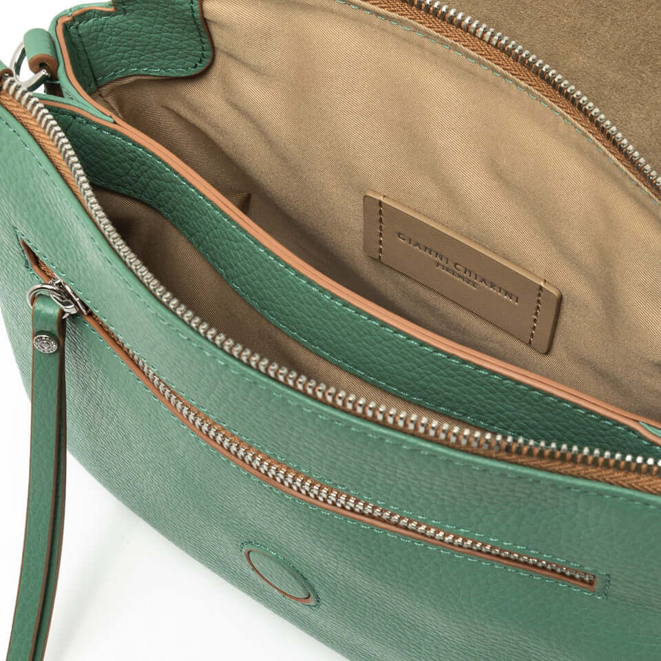Interior view of the green leather Three Gianni Chiarini Firenze handbag, showcasing its compartments and detailing.