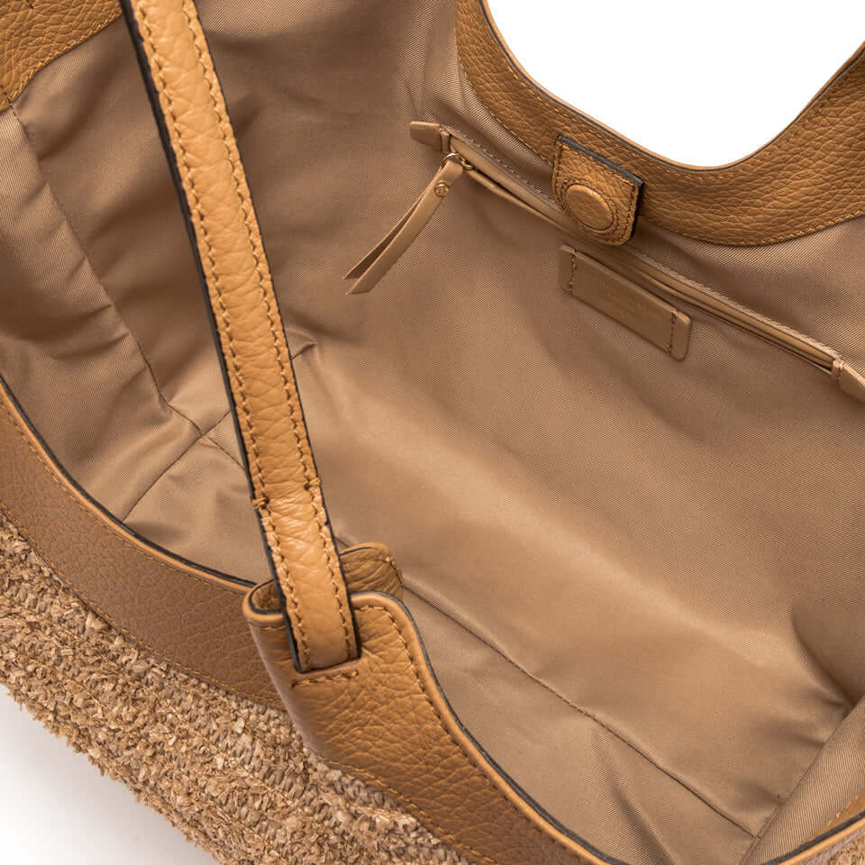 Interior view of the DUA straw bag showcasing its spacious, unlined compartment and leather accents.