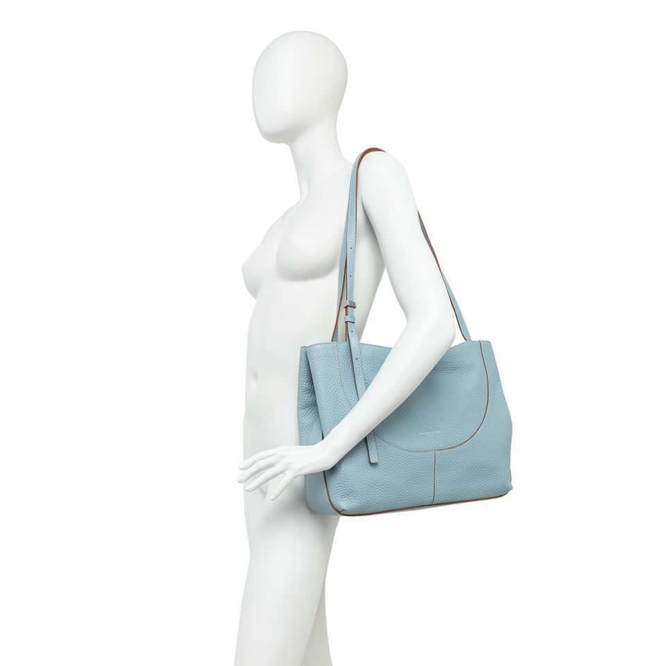 Light blue Gianni Chiarini Firenze Minerva bag on a mannequin, featuring a clean design and practical shoulder carry.