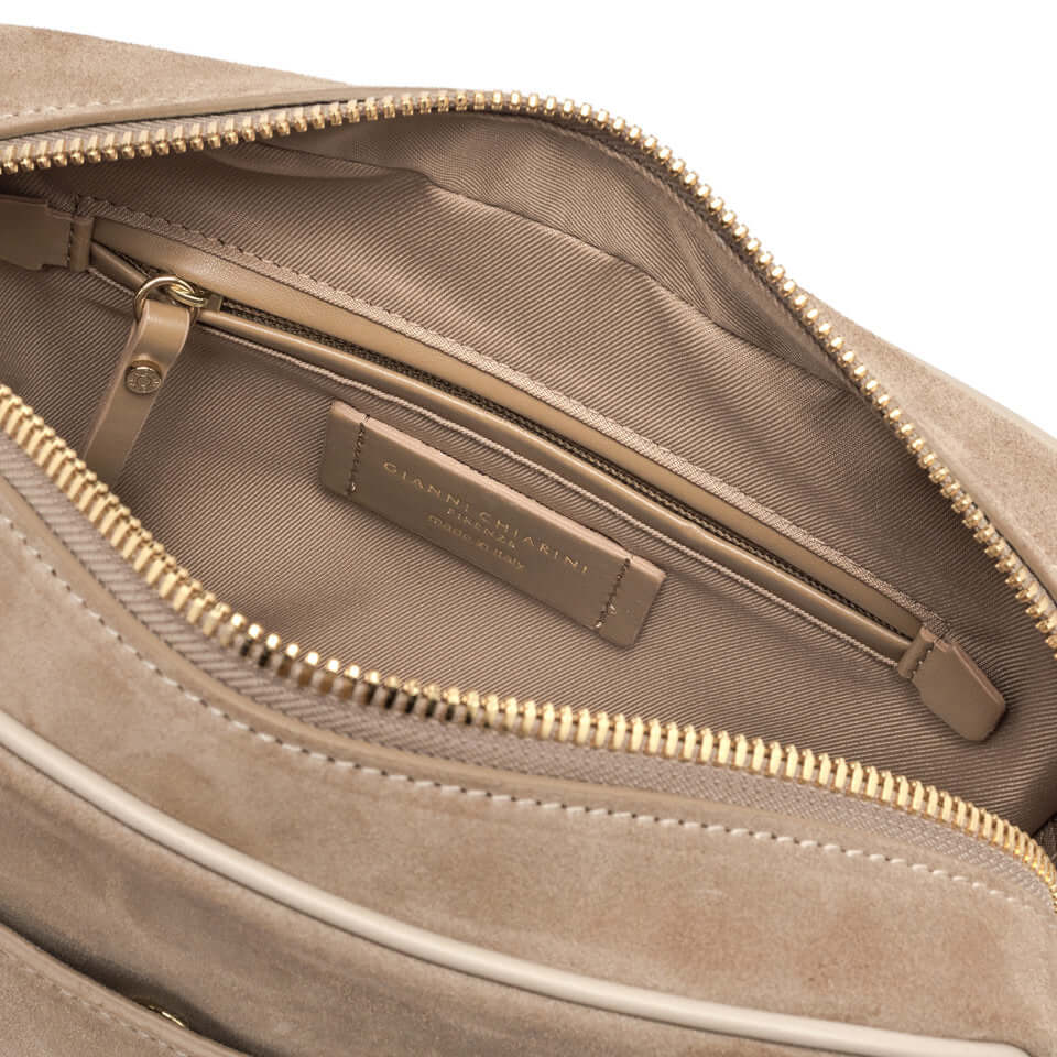 Interior view of NINA by Gianni Chiarini Firenze showing the zip compartment and logo label in beige suede.