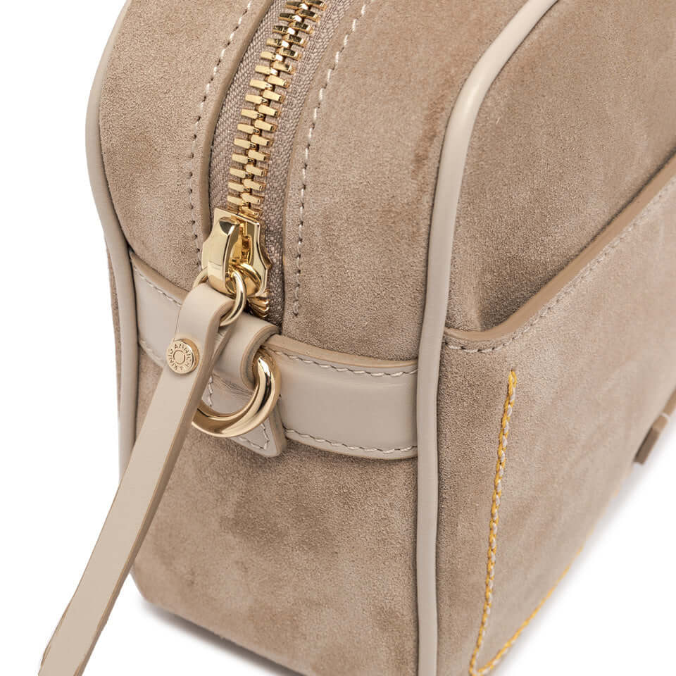 Close-up of the Nina by Gianni Chiarini Fiorenze suede handbag showcasing its zipper and detailed stitching.