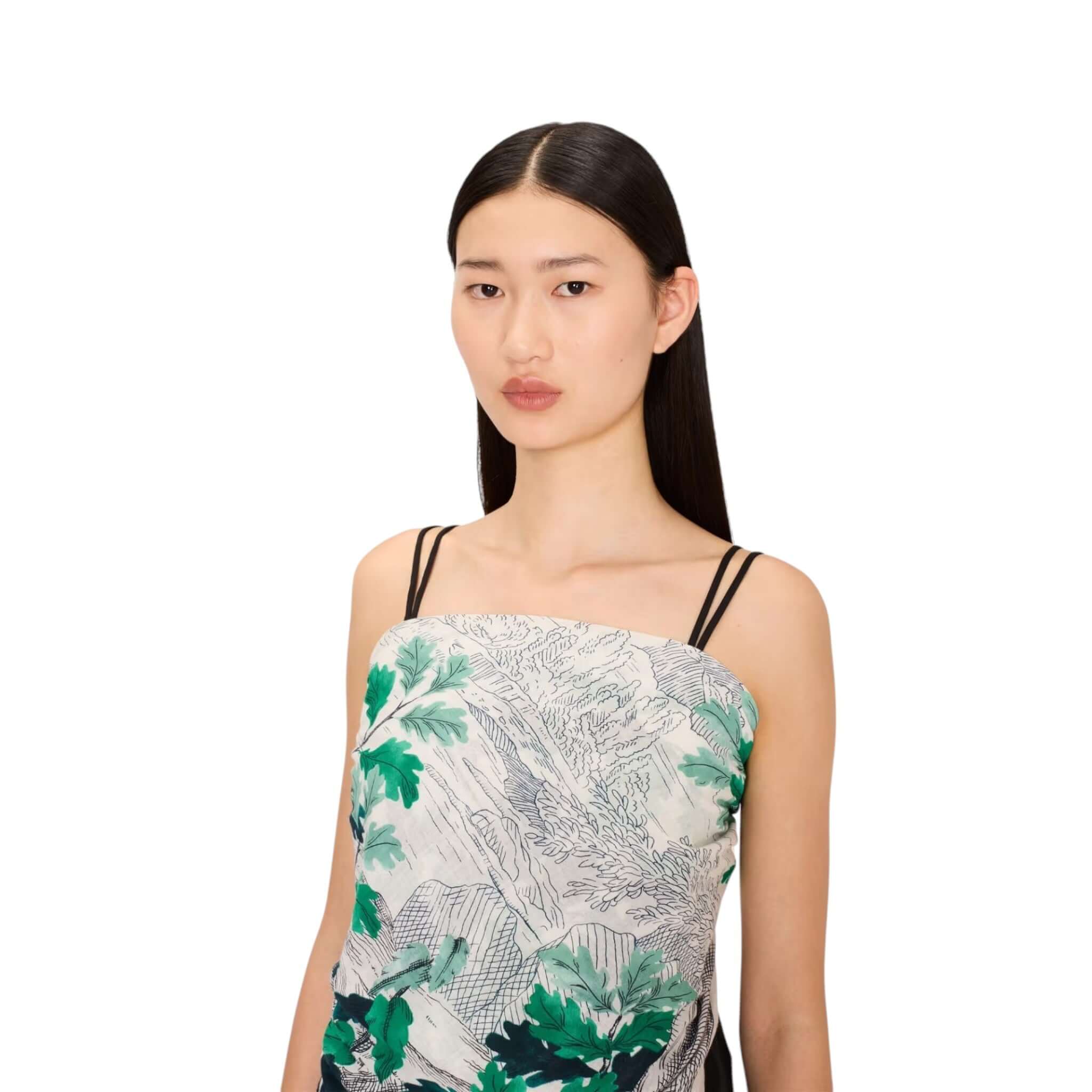Model showcasing the Foulard Quadrato Amboise with green leaf print, perfect for adding elegance to any outfit.