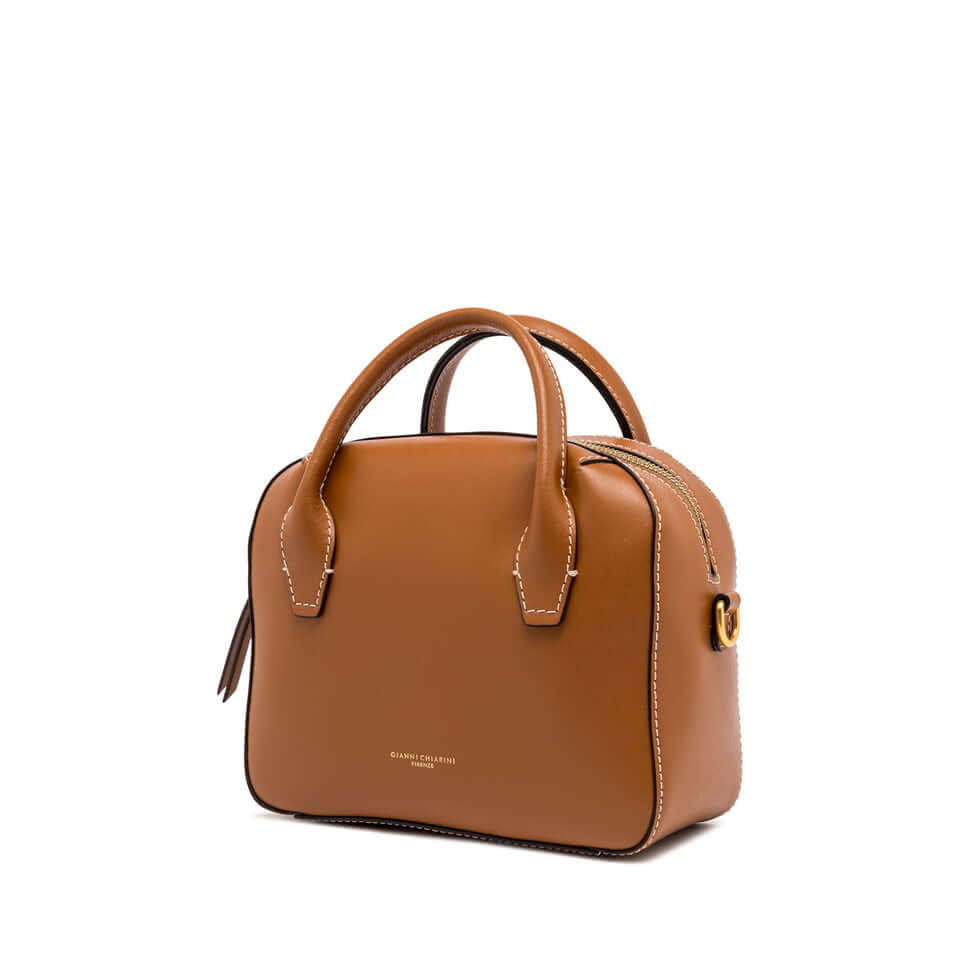 Sabrina small bowling bag in smooth leather, compact design with double handles and shoulder strap, perfect for day wear.