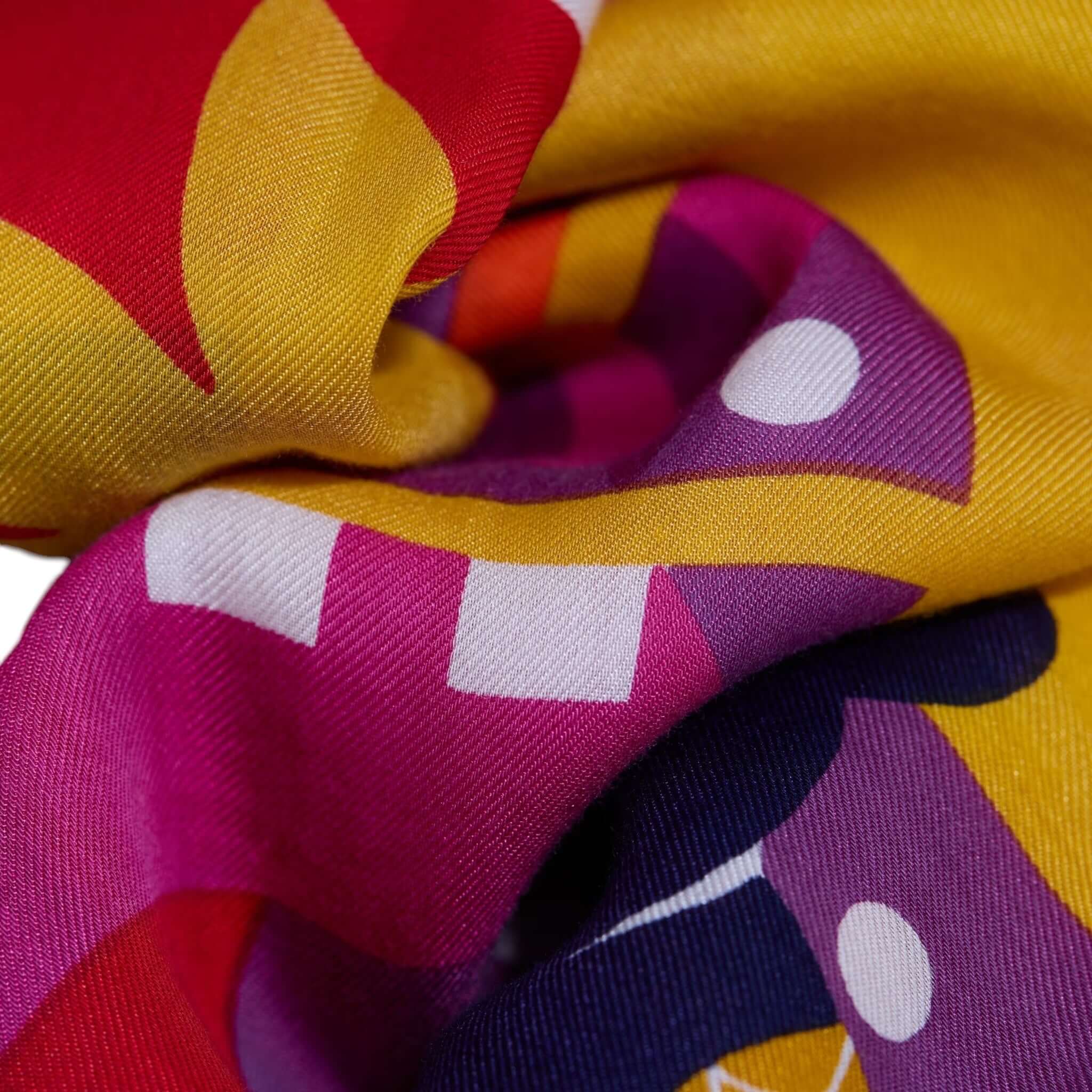 Colorful Sciarpa Rollercoaster, handmade scarf featuring vibrant prints in yellow, red, and purple, ideal for stylish wear.