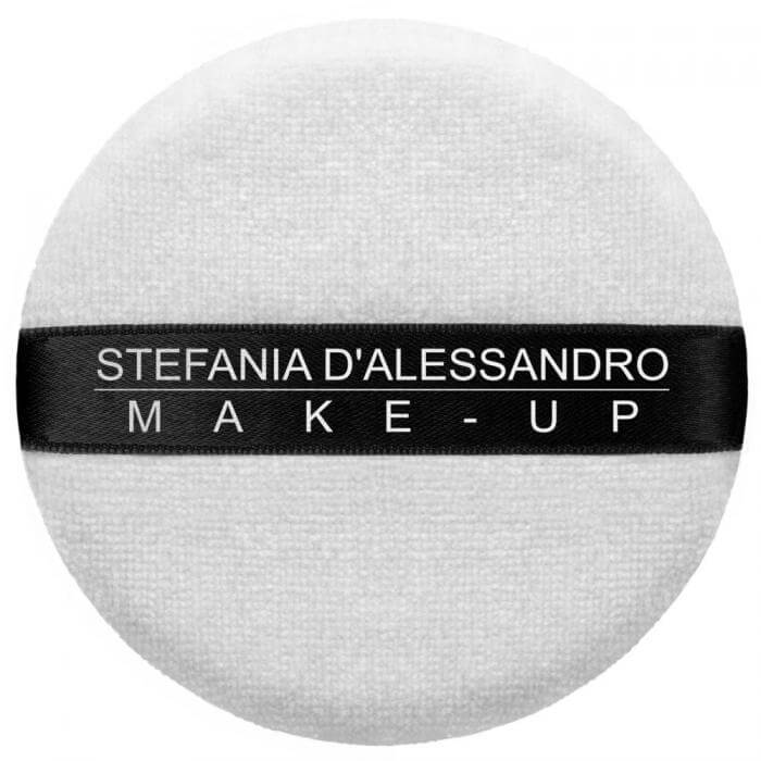 Make-up puff by Stefania D'Alessandro, round white cosmetic applicator with black branding ribbon.
