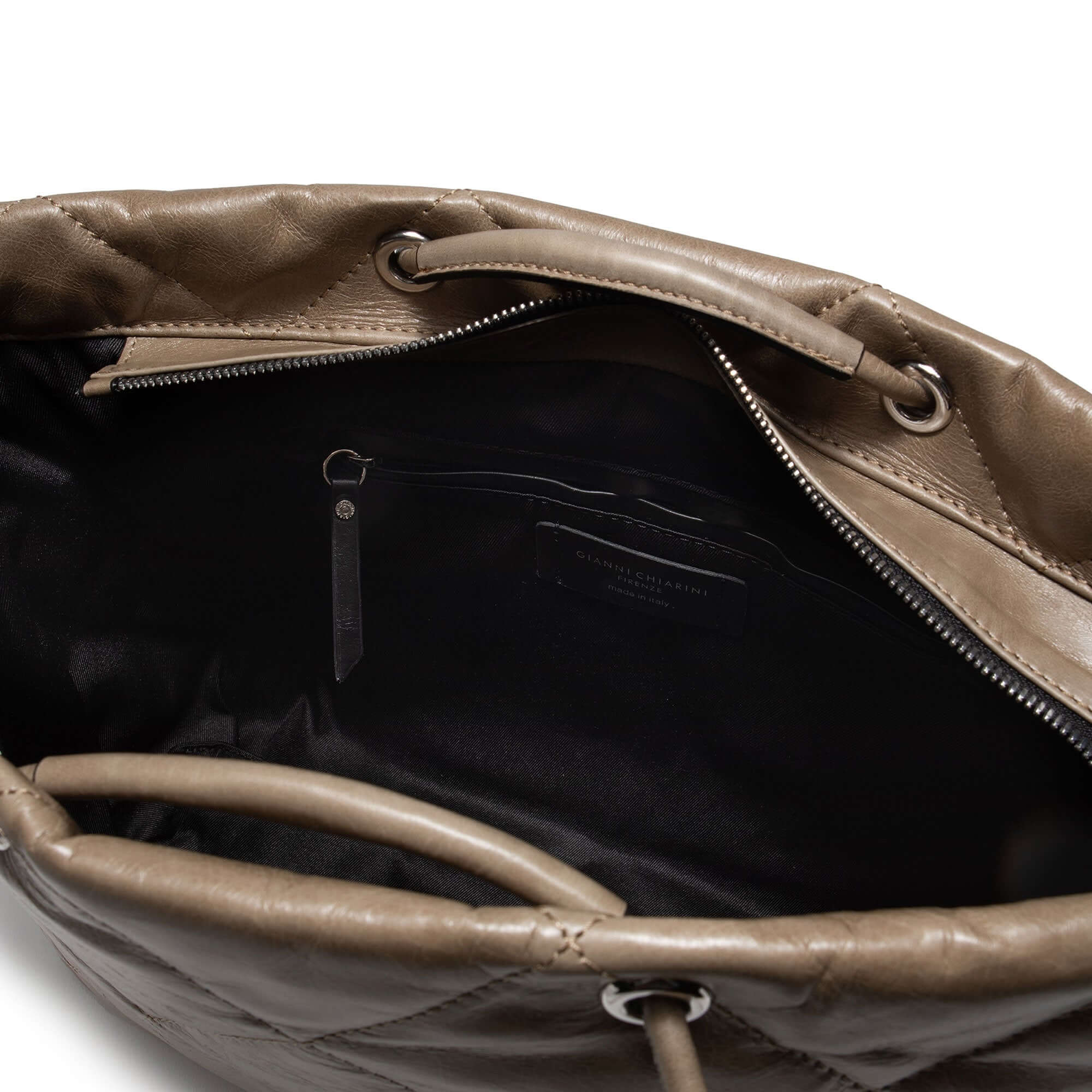 Inside view of the KATE handbag, showcasing smooth leather, zip closure, and spacious interior.