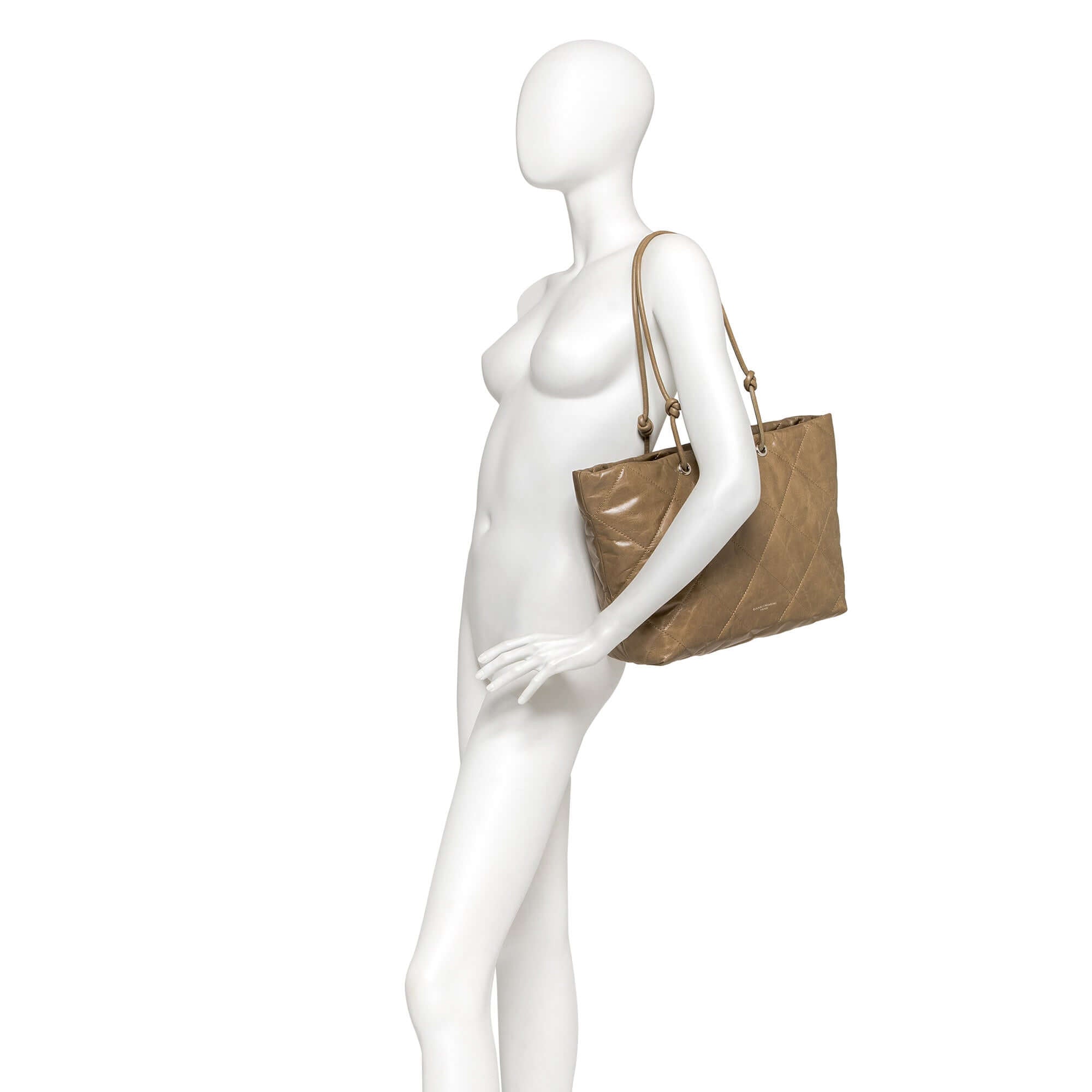 KATE bag in soft quilted leather, showcasing adjustable handles for hand or shoulder carry.