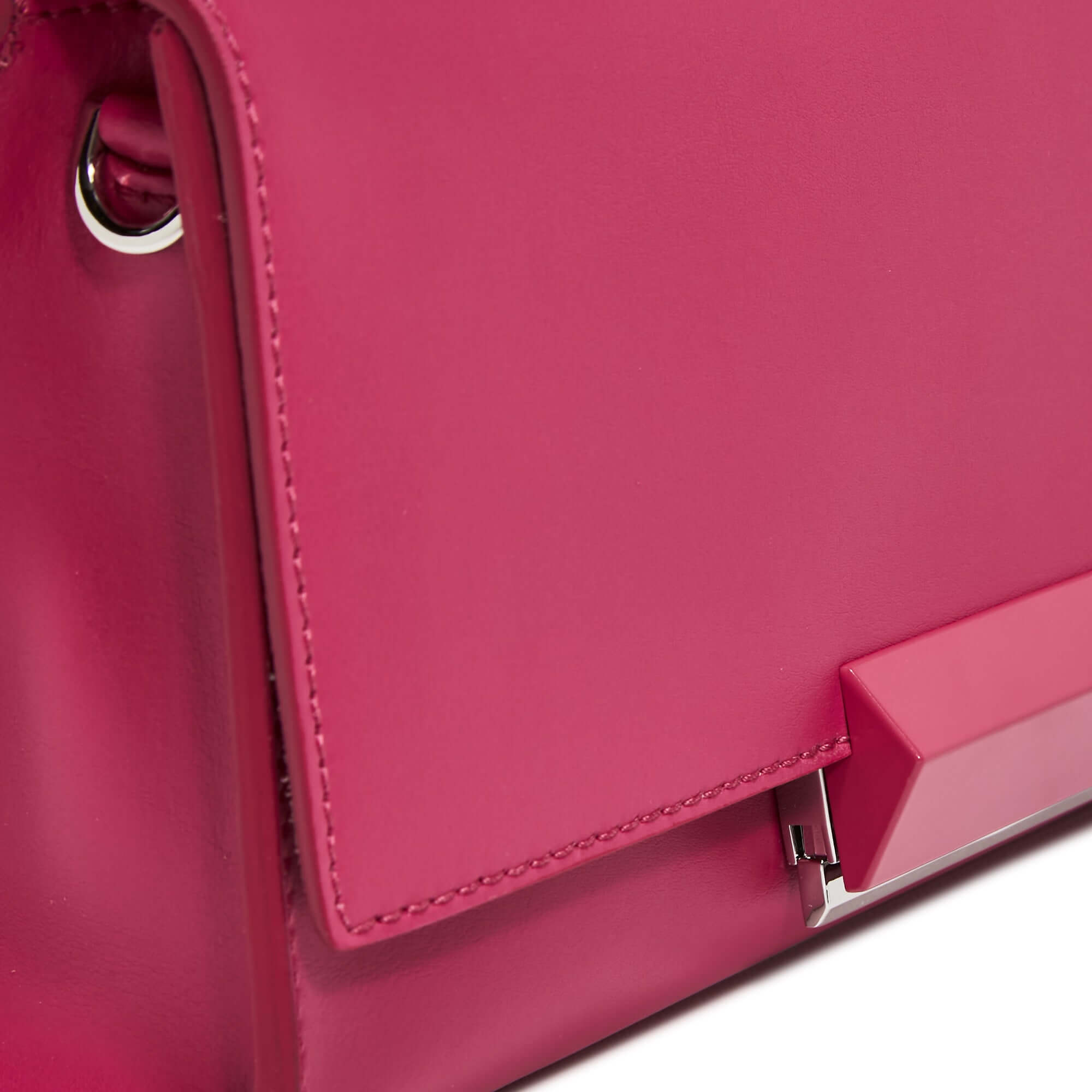 Close-up of the pink Lily clutch by Gianni Chiarini, featuring a smooth leather finish and snap closure.