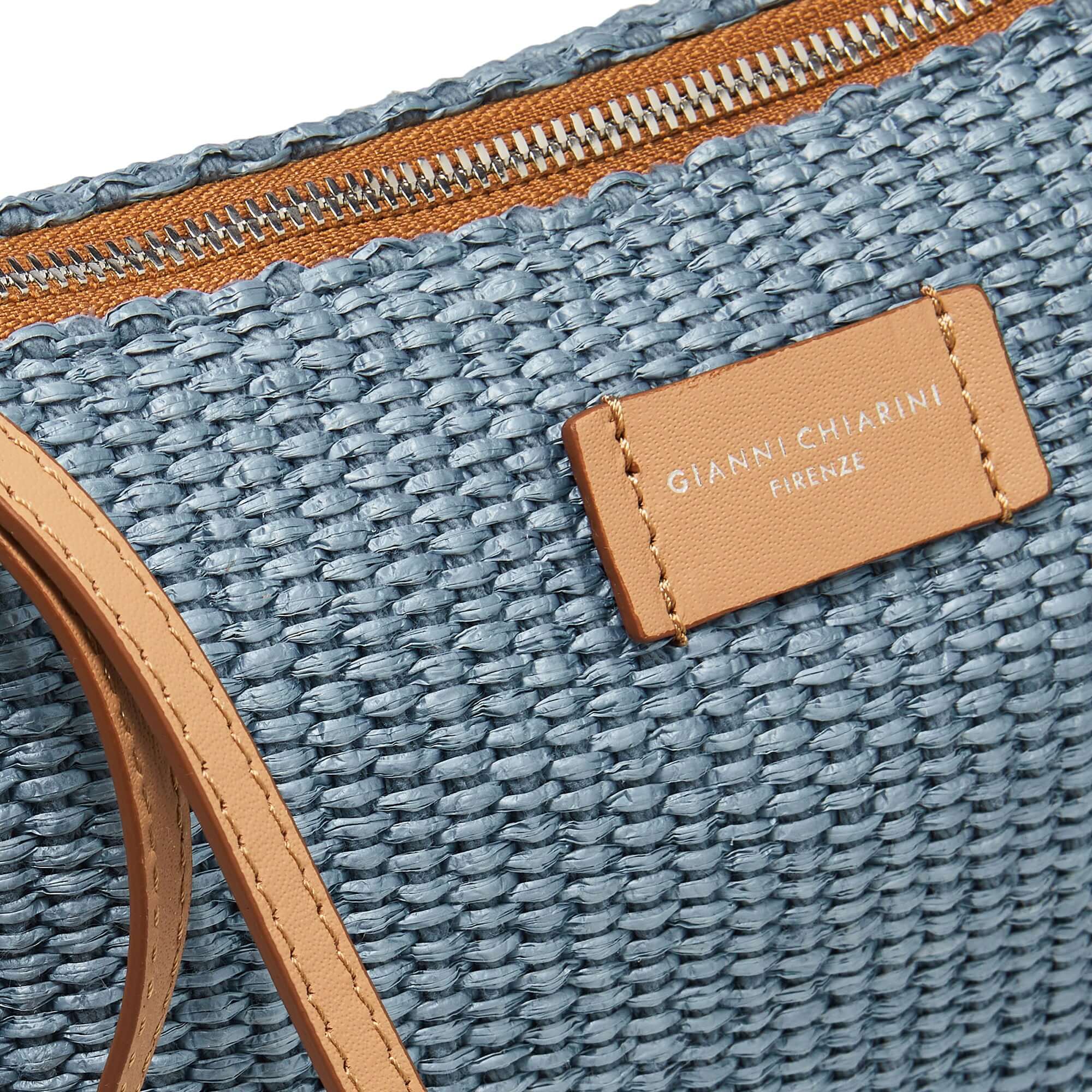 NORA POUCH in straw with smooth leather strap, zipper closure, and adjustable removable crossbody strap.