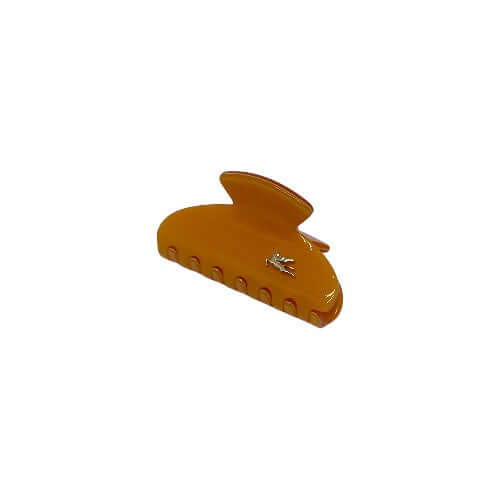 Pinza arancio con pegaso, realizzata in acetato, vetro e acciaio, ideale per fissare i capelli in modo elegante.