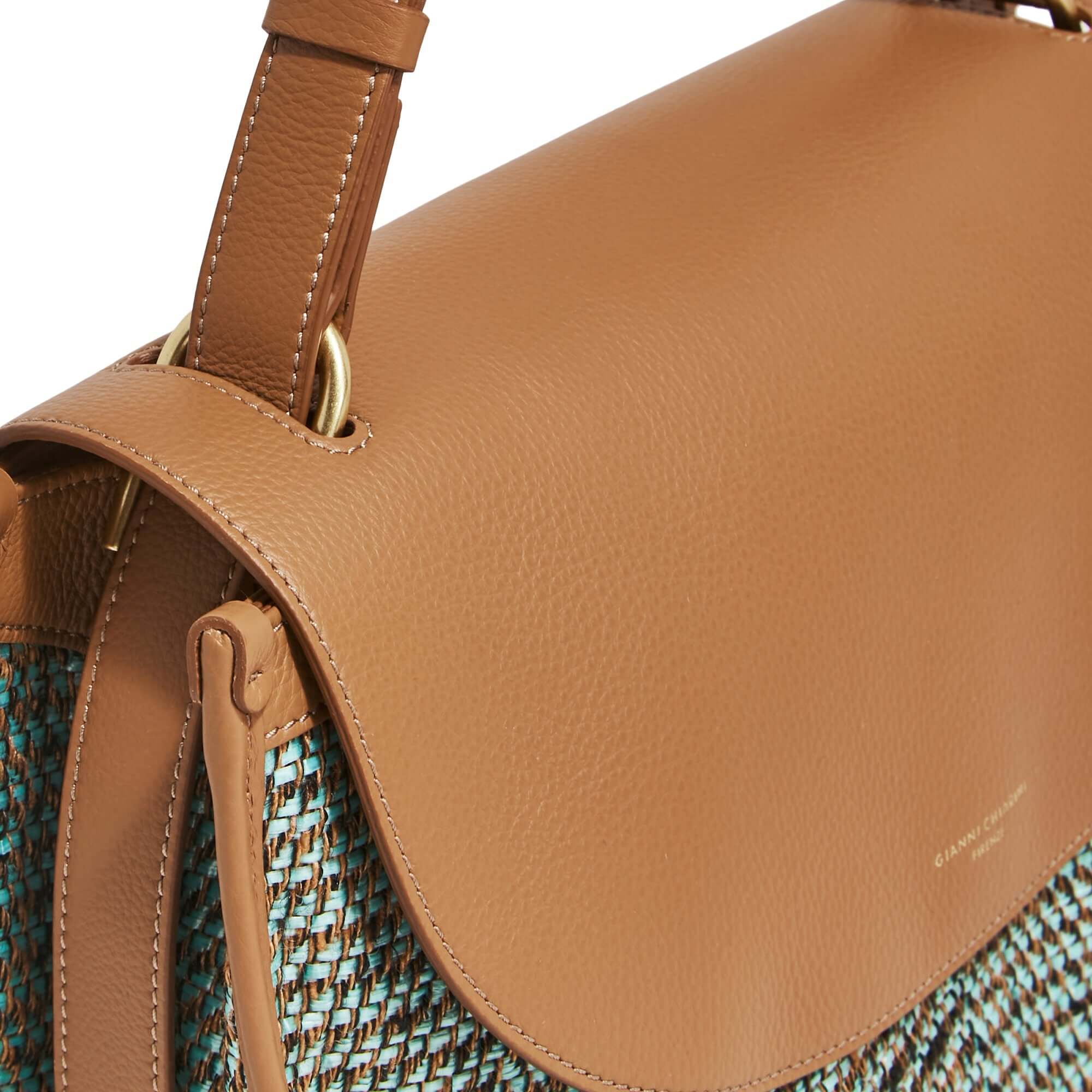 Detail of Louise shoulder bag by Gianni Chiarini, featuring woven raffia and adjustable leather strap.
