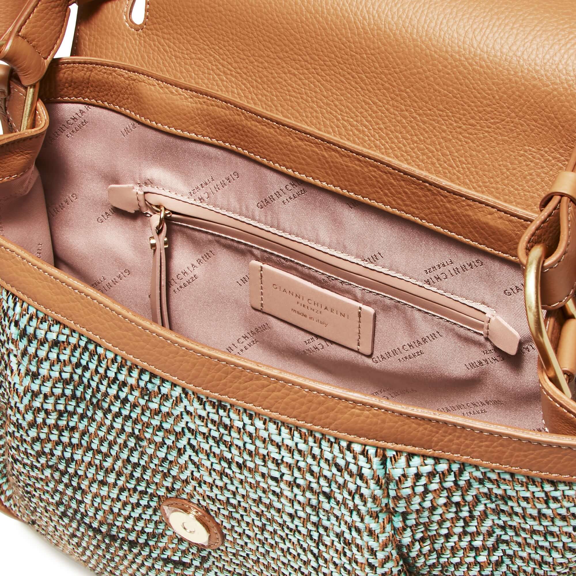 Interior view of Gianni Chiarini's Louise shoulder bag, featuring woven raffia and leather with a zip pocket.