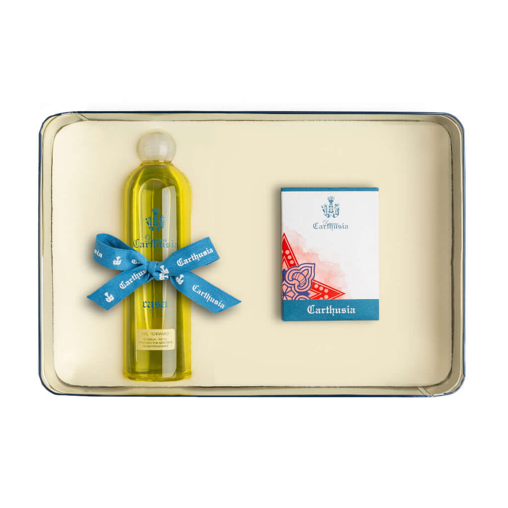 Carthusia gift set with yellow fragrance bottle and decorative packaging on tray.