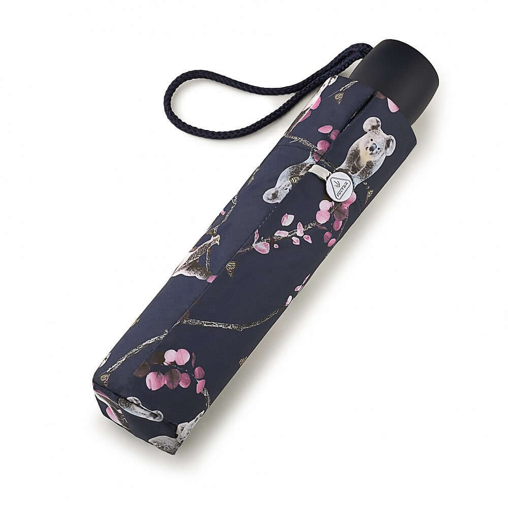 Ombrello Kiran il Coala: chiuso, leggero e robusto, con motivo di koala e fiori, ideale per la pioggia.